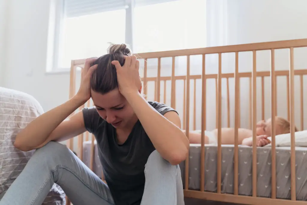exhausted parent trying to get child to sleep